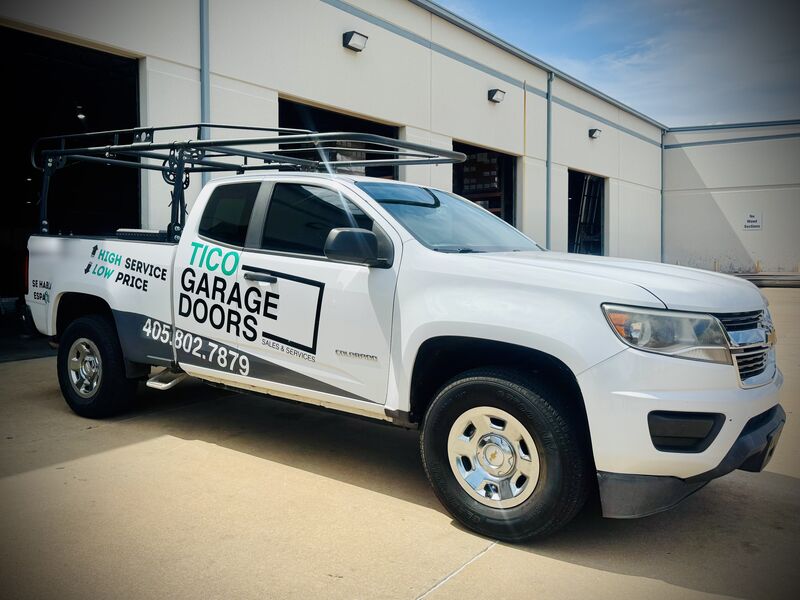 Tico Garage Doors work truck with the phone number 405-802-7879 on the door